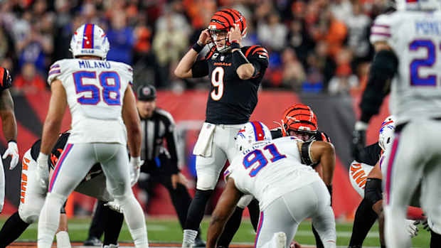 Cincinnati Bengals quarterback Joe Burrow (9) resets a play before running a QB sneak for a first down in the first quarter of the NFL Week 17 game between the Cincinnati Bengals and the Buffalo Bills at Paycor Stadium in Downtown Cincinnati on Monday, Jan. 2, 2023. The game was suspended with suspended in the first quarter after Buffalo Bills safety Damar Hamlin (3) was taken away in an ambulance following a play.